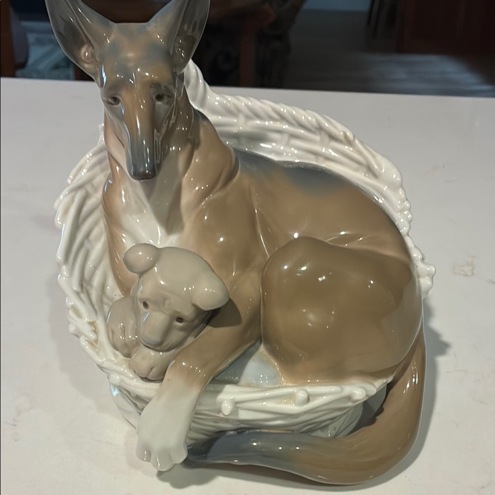 Lladro German Shepherd and her pup in a basket.
